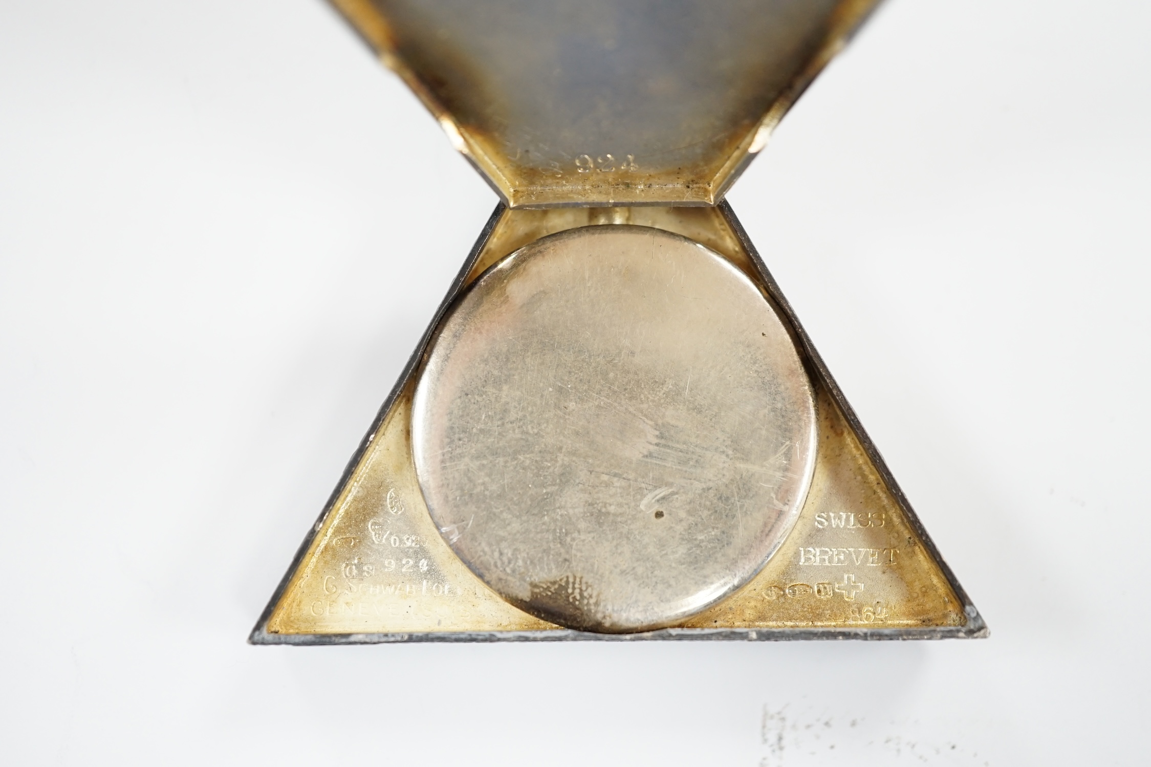 A 1920's Swiss silver triangular Masonic timepiece, with mother of pearl dial, import marks for George Stockwell, London, 1928, 0verall 65mm (lacking minute hand).